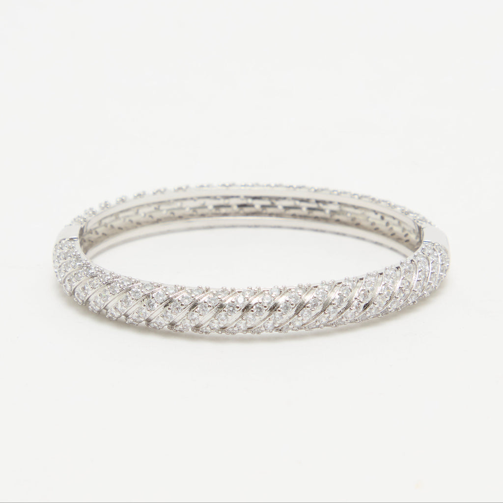 Silver ring with a textured band on a white background