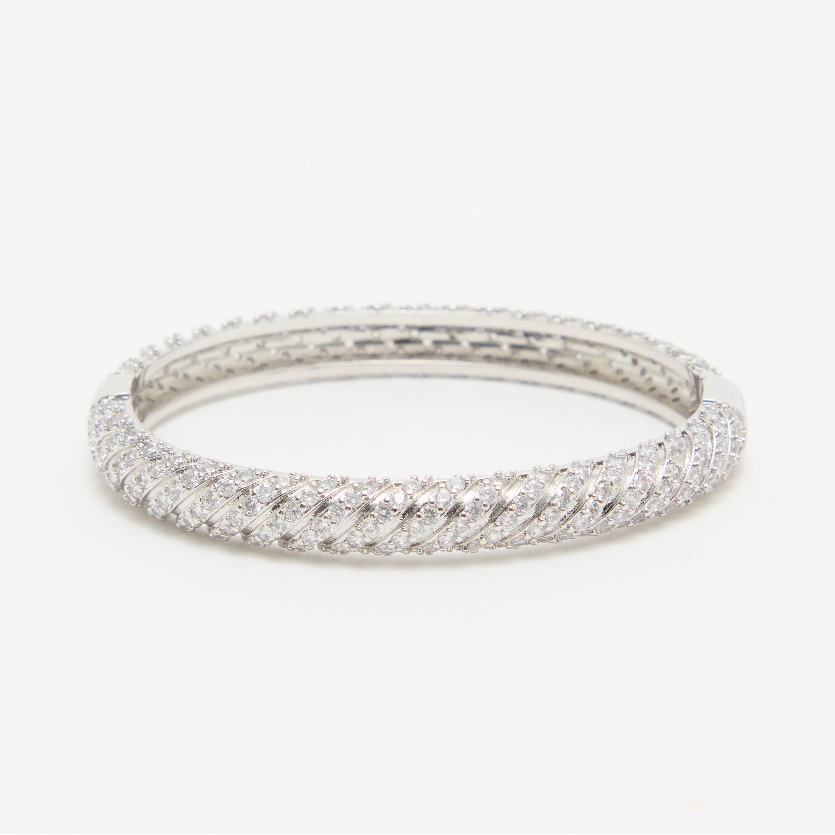 Silver ring with a textured band on a white background