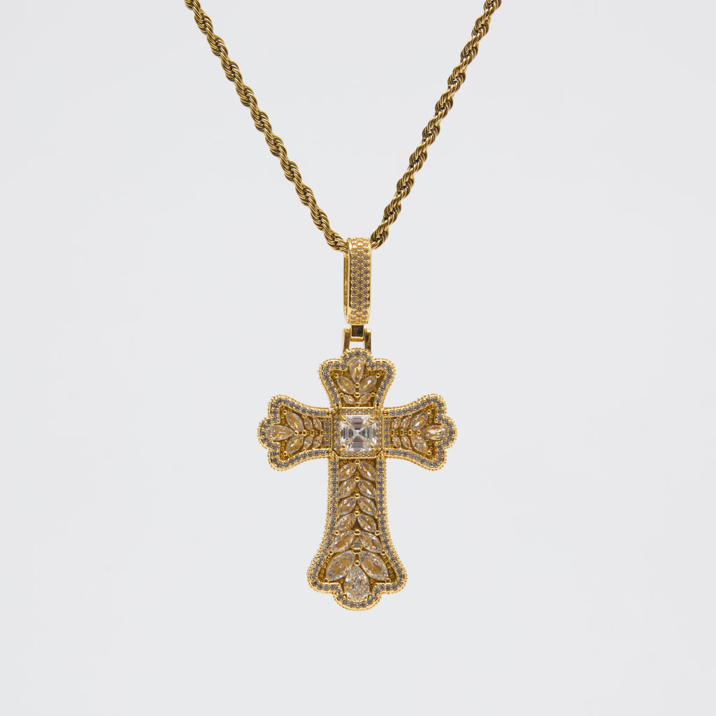 Gold cross pendant necklace on a white background