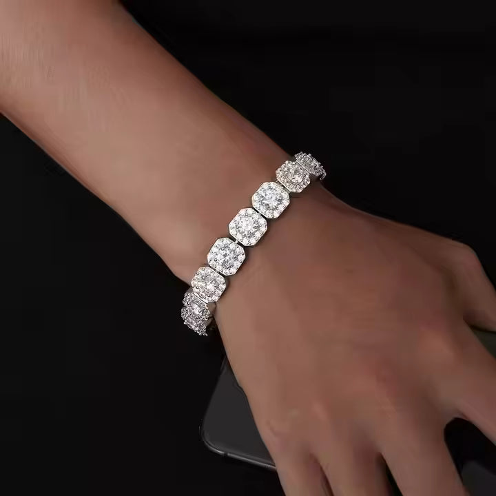 Diamond bracelet on a wrist against a dark background