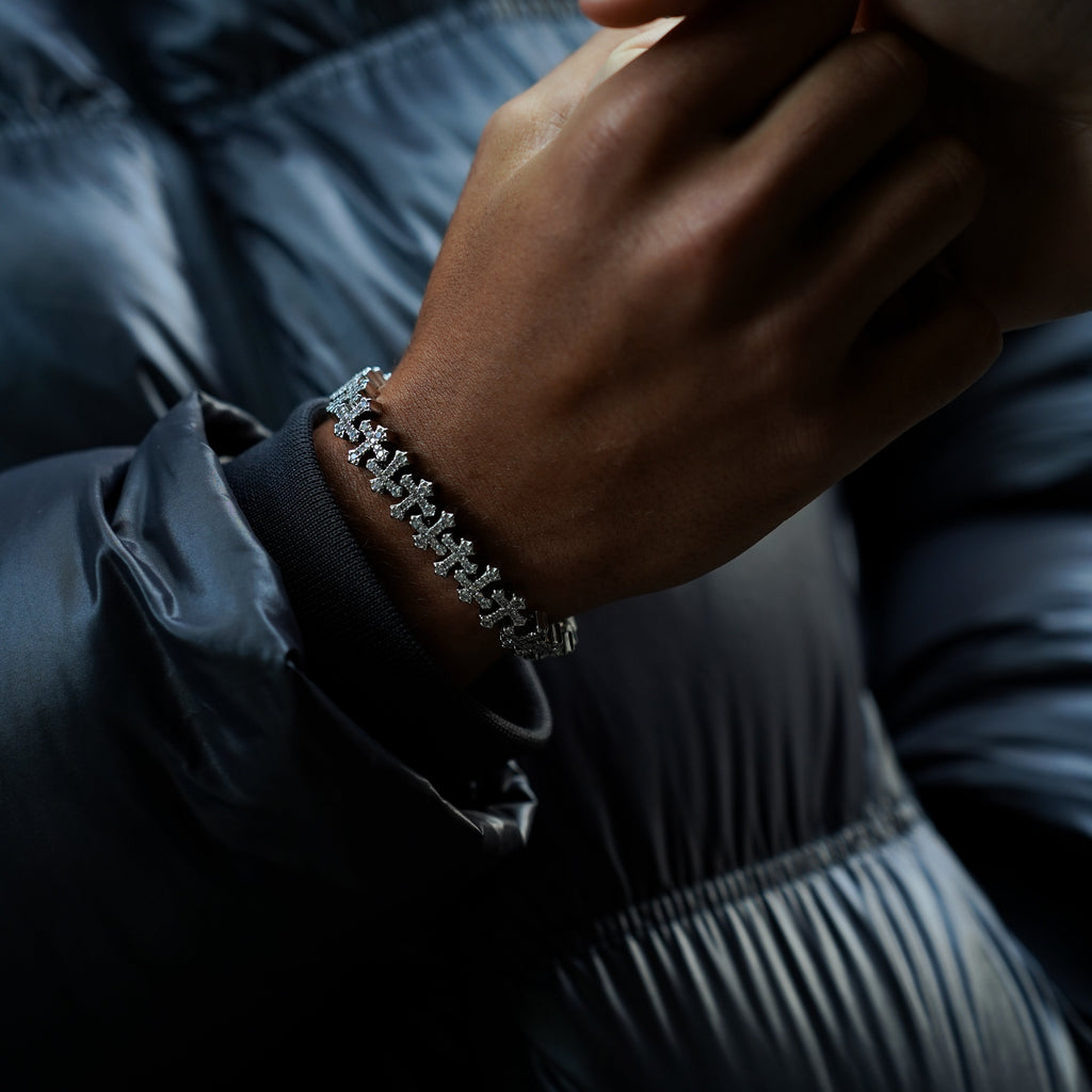 Close-up of a hand wearing a bracelet with a dark background