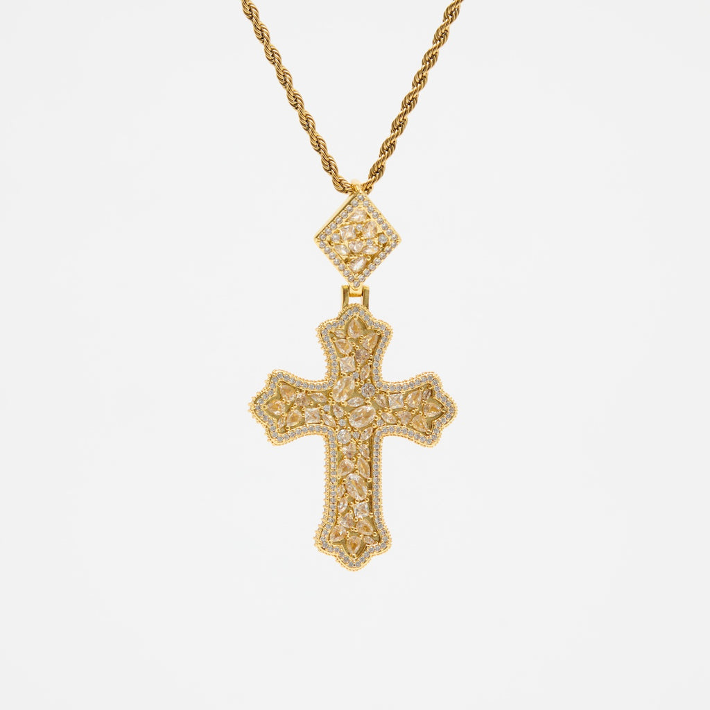 Gold cross necklace with diamond accents on a white background