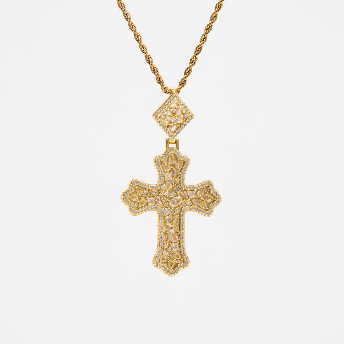 Gold cross necklace with diamond accents on a white background