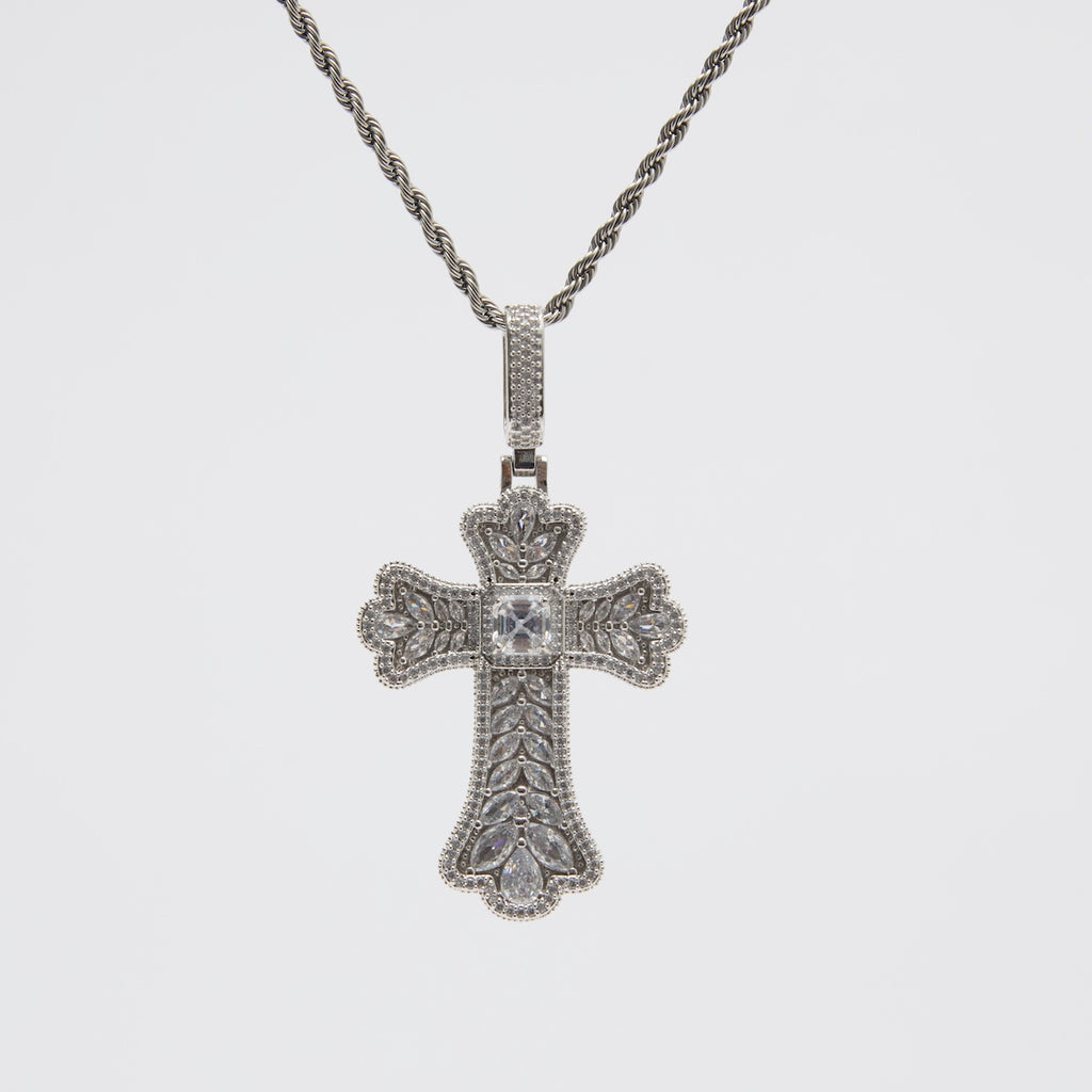 Silver cross pendant necklace on a light gray background