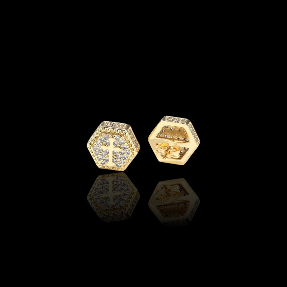 Hexagonal gold earrings on a black background
