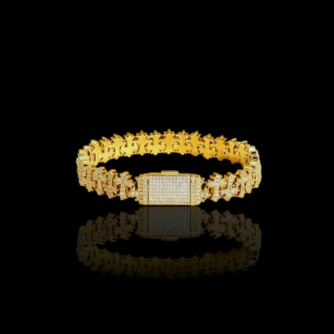 Gold bracelet with a rectangular clasp on a black background