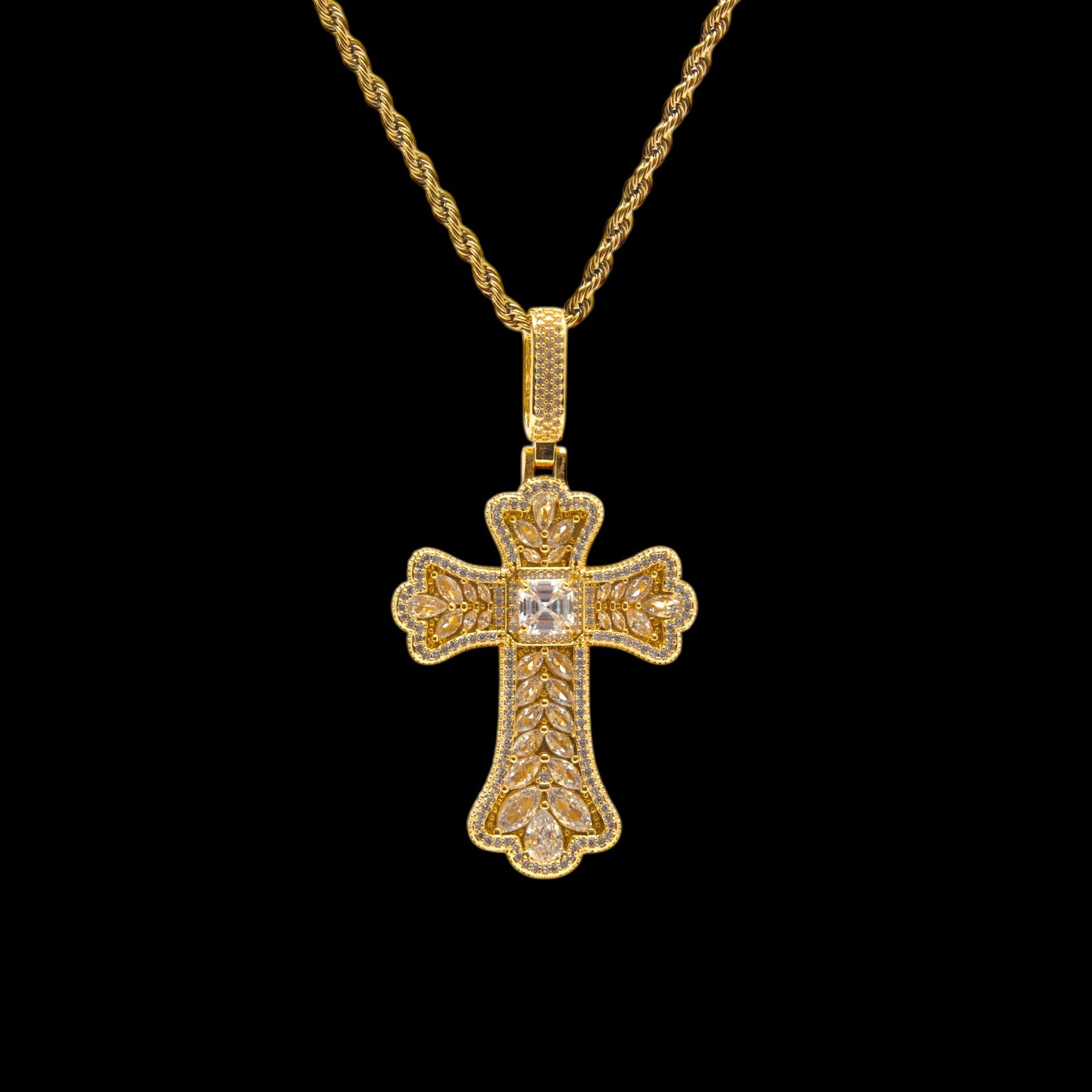 Gold cross pendant necklace on a black background