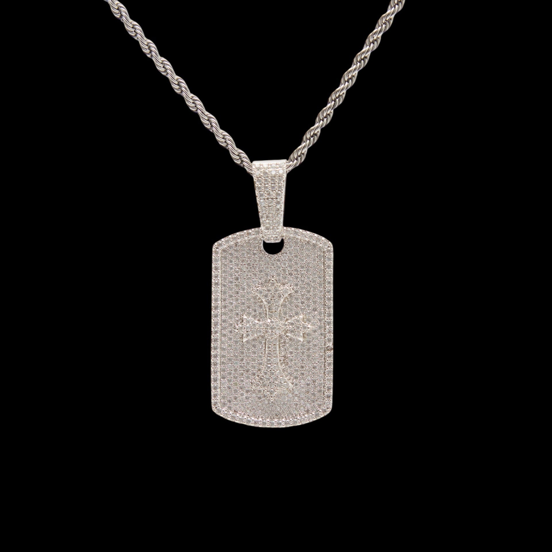 Silver dog tag pendant on a black background