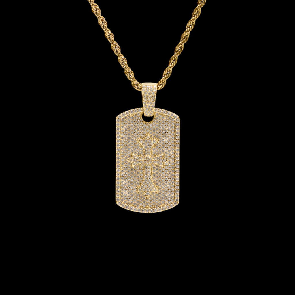 Gold necklace with a dog tag pendant featuring a cross design on a black background