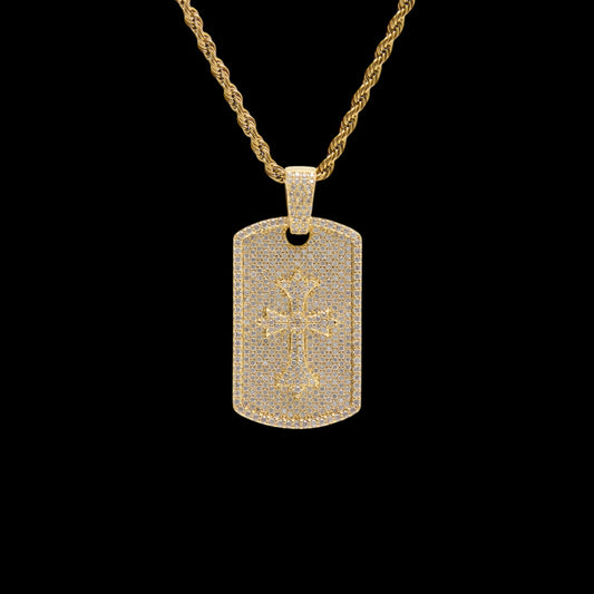 Gold necklace with a dog tag pendant featuring a cross design on a black background