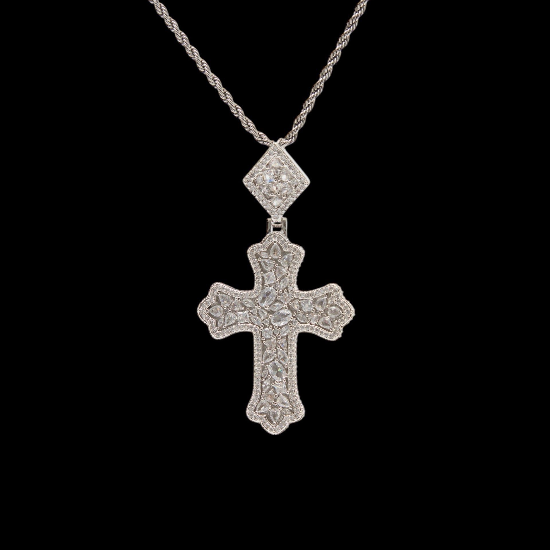 Silver cross pendant necklace on a black background