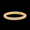 Gold bracelet with diamond accents on a black background