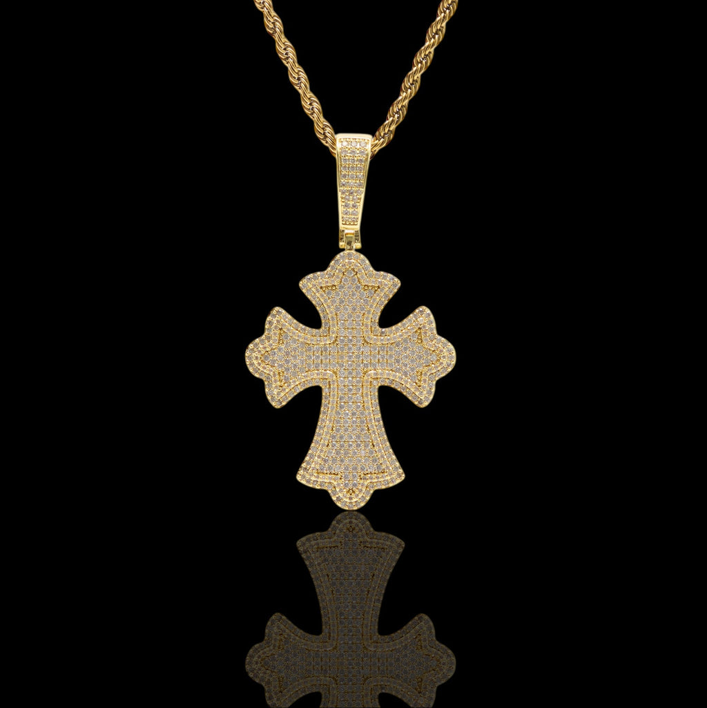 Gold cross pendant necklace on a black background