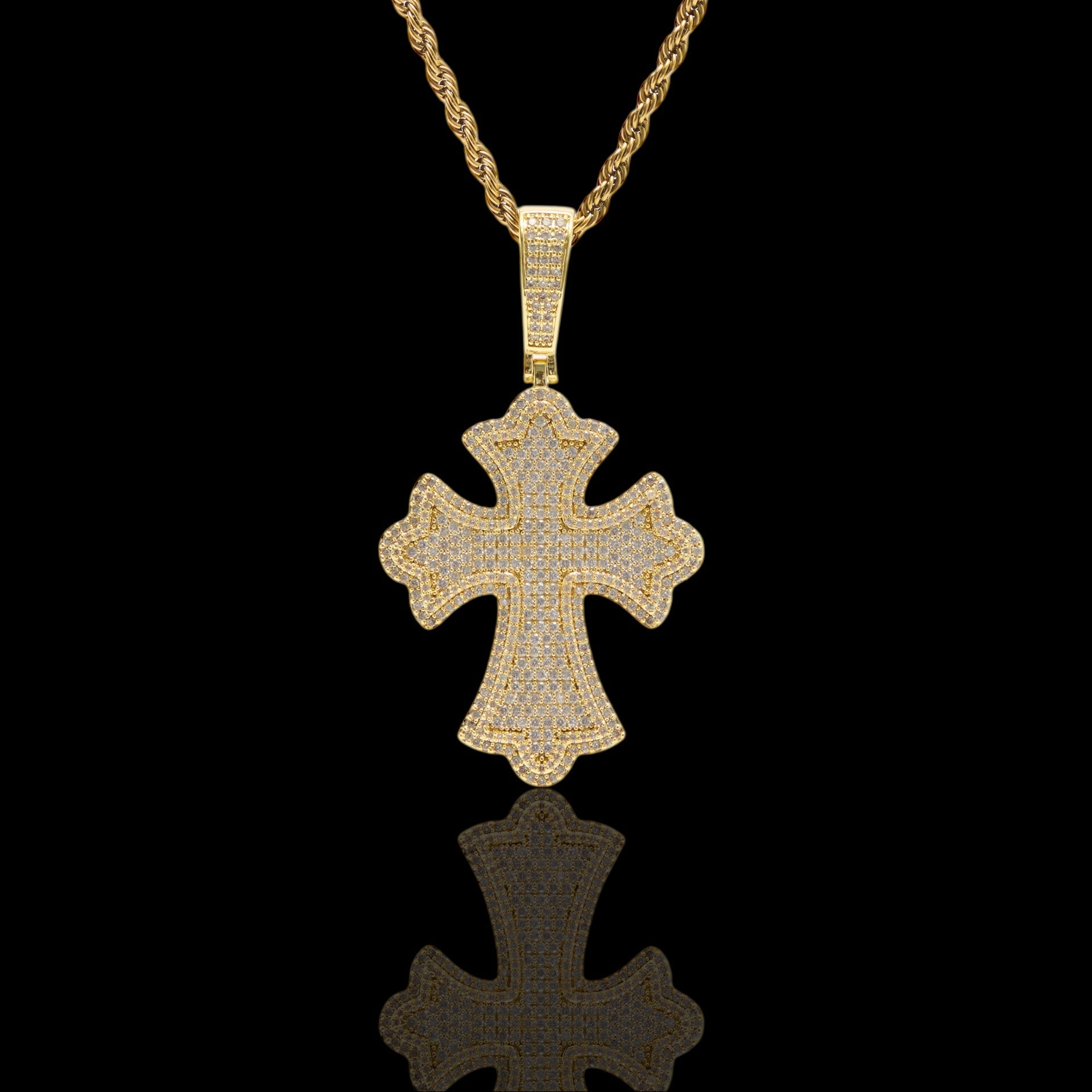 Gold cross pendant necklace on a black background
