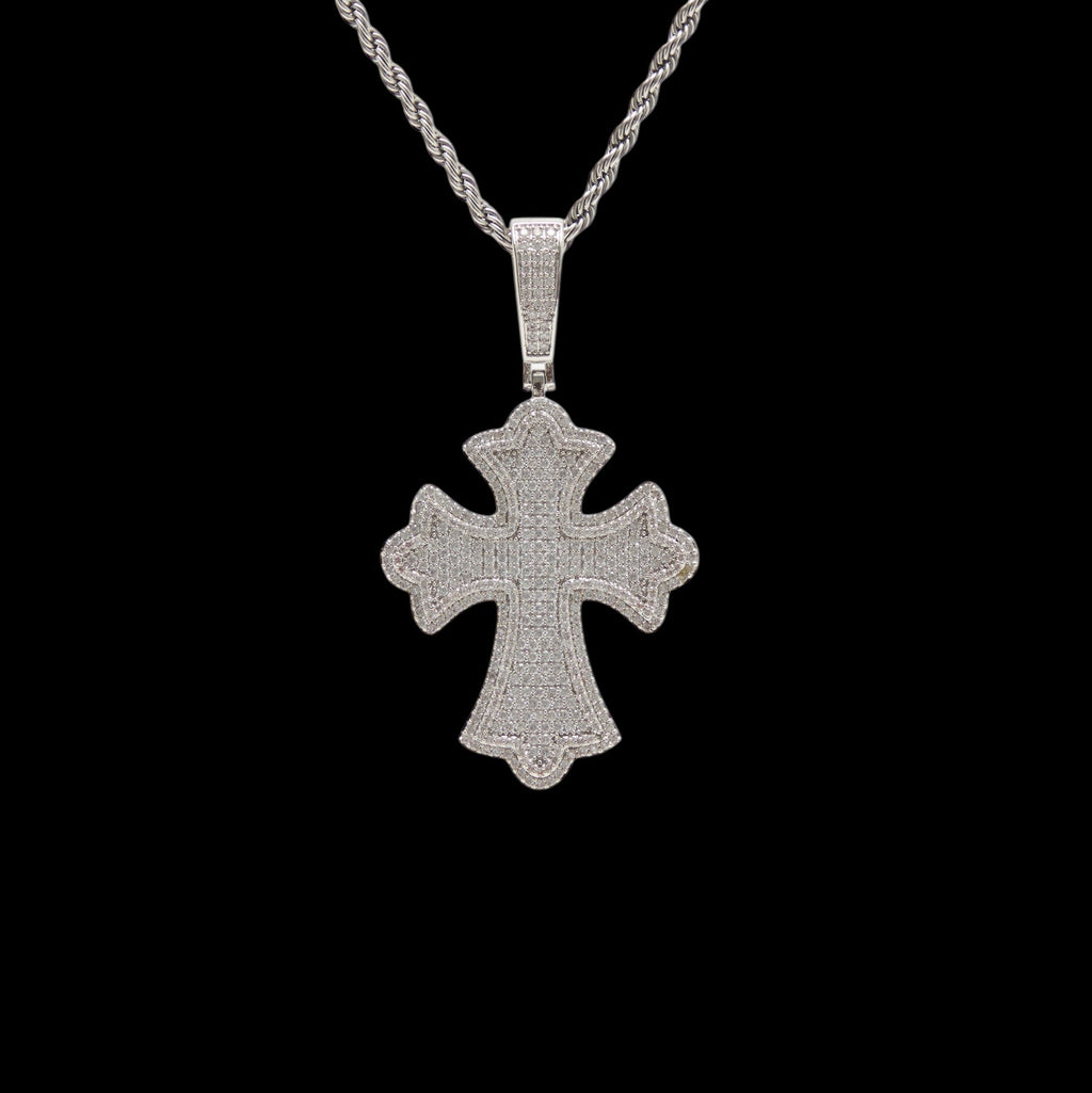 Silver cross pendant on a black background