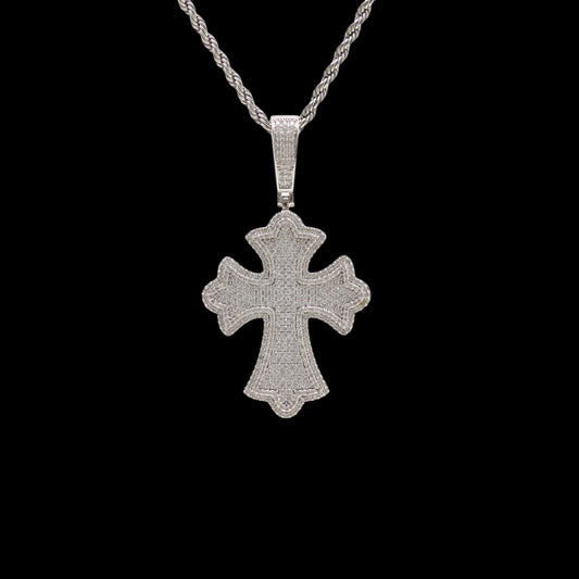 Silver cross pendant on a black background